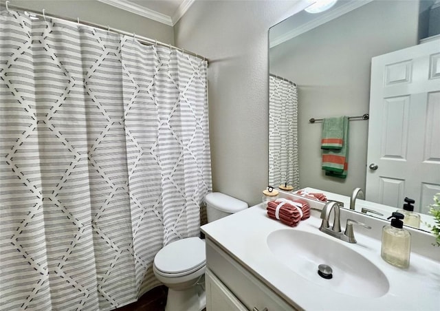 bathroom with crown molding, vanity, and toilet