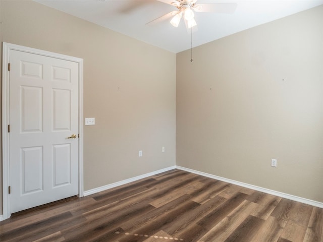 spare room featuring dark wood-type flooring and ceiling fan