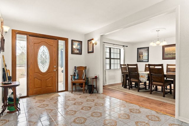 entryway featuring light hardwood / wood-style floors and a notable chandelier