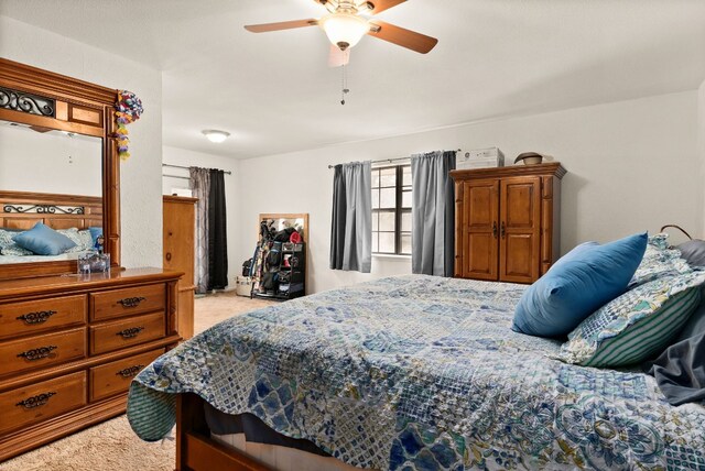 bedroom with ceiling fan and light colored carpet