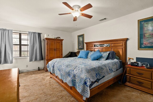 bedroom featuring ceiling fan and carpet