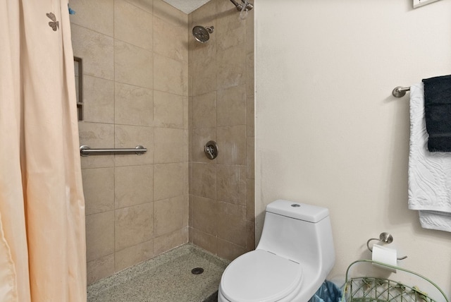 bathroom with toilet and a shower with curtain