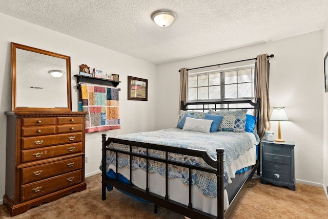 carpeted bedroom featuring a textured ceiling