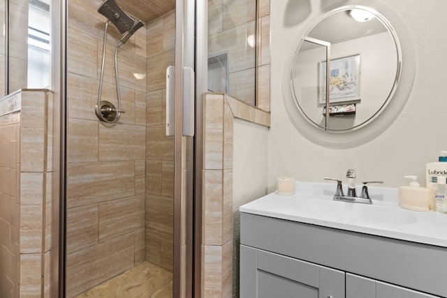 bathroom with vanity and a shower with door