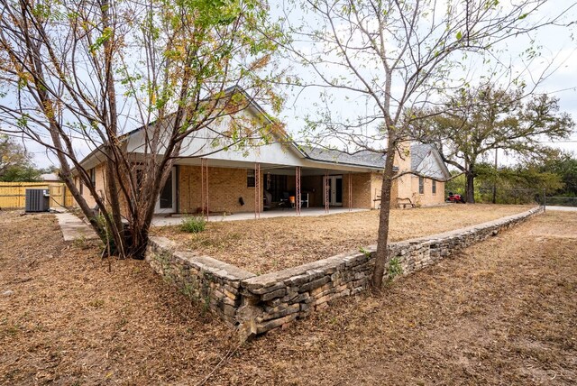 back of property featuring a patio area and cooling unit