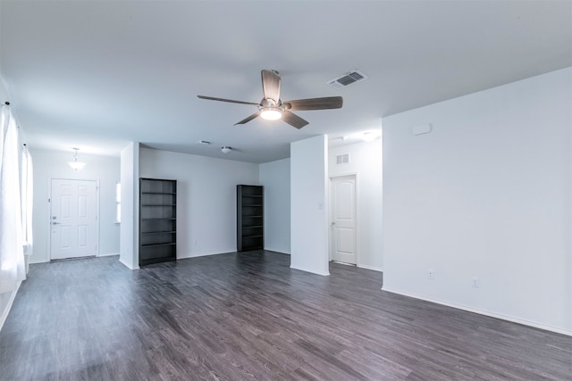 unfurnished living room with ceiling fan and dark hardwood / wood-style floors