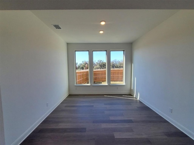 empty room with dark hardwood / wood-style floors