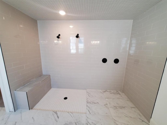 bathroom with a tile shower