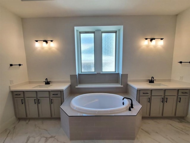 bathroom featuring vanity and a relaxing tiled tub