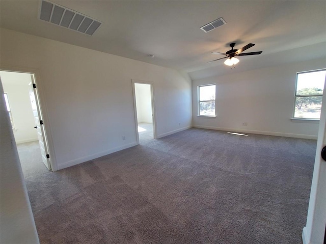 carpeted spare room with ceiling fan and lofted ceiling