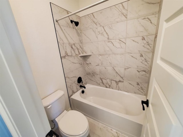 bathroom with tiled shower / bath combo and toilet