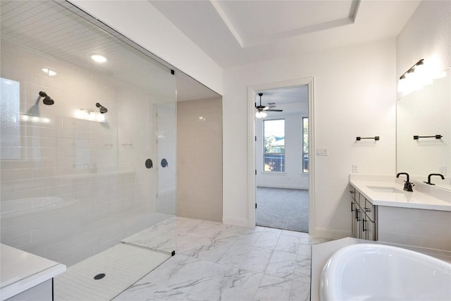 bathroom featuring vanity, ceiling fan, a raised ceiling, and separate shower and tub