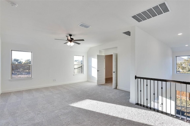 unfurnished room featuring vaulted ceiling, carpet floors, and ceiling fan