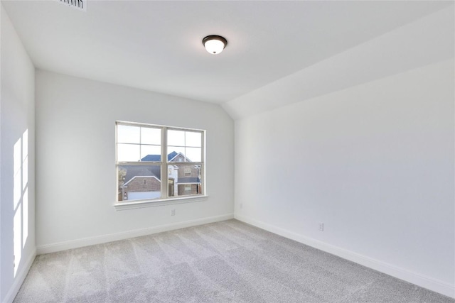 empty room with light carpet and lofted ceiling