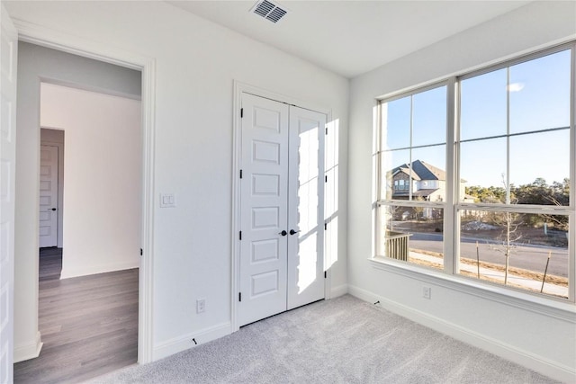 foyer entrance with light colored carpet