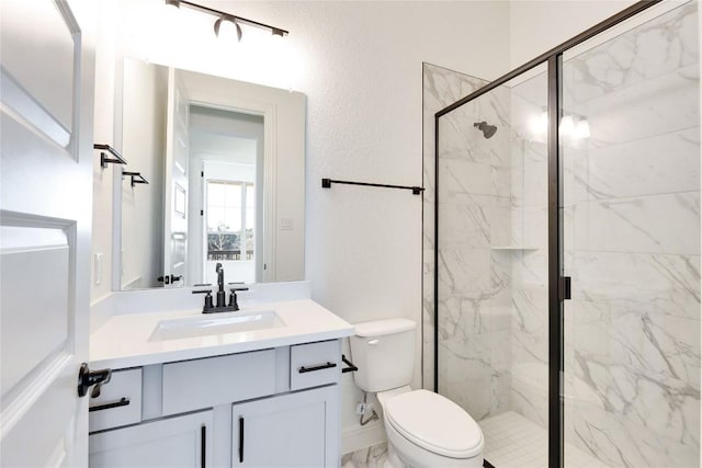 bathroom with vanity, toilet, and walk in shower