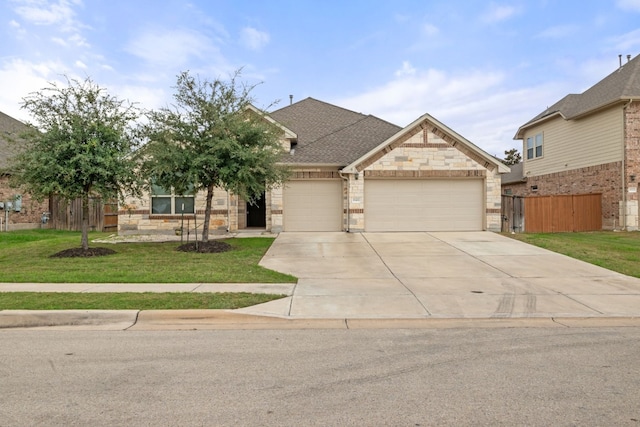 craftsman house with a garage and a front lawn