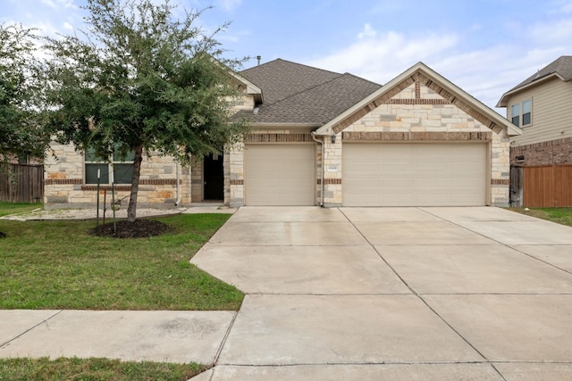 view of front facade featuring a garage and a front lawn