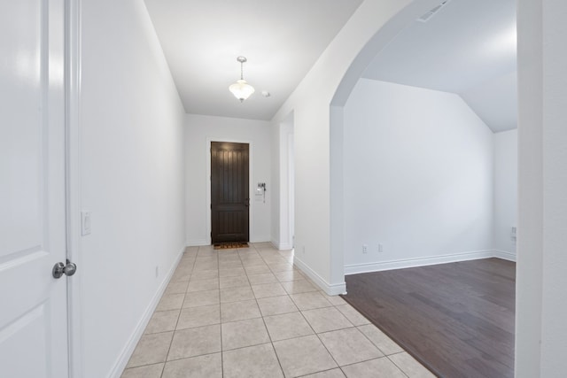 interior space with lofted ceiling and light hardwood / wood-style flooring