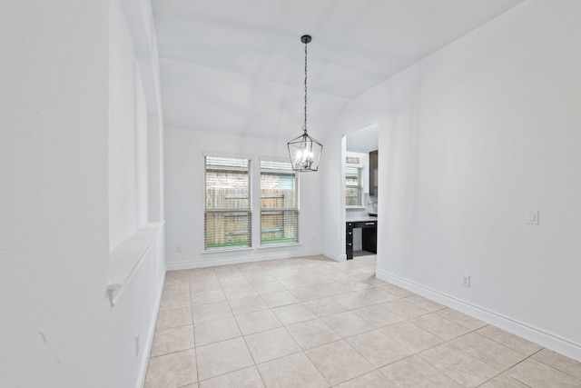 unfurnished dining area with lofted ceiling, an inviting chandelier, and light tile patterned flooring