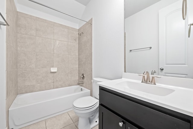 full bathroom featuring vanity, tile patterned floors, toilet, and tiled shower / bath combo