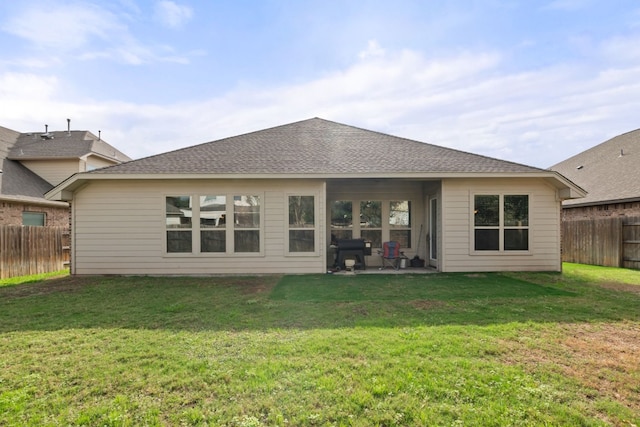 back of property featuring a lawn and a patio area