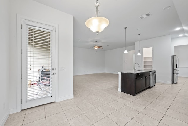 kitchen featuring appliances with stainless steel finishes, decorative light fixtures, light tile patterned floors, sink, and ceiling fan