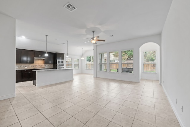 unfurnished living room with a wealth of natural light, ceiling fan, and light tile patterned flooring