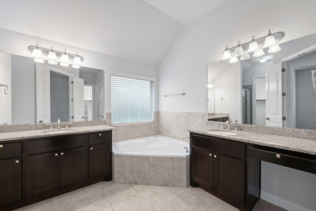 bathroom featuring vanity, lofted ceiling, tile patterned floors, and shower with separate bathtub