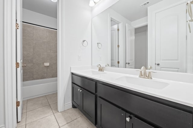 bathroom with vanity, tile patterned floors, and tiled shower / bath