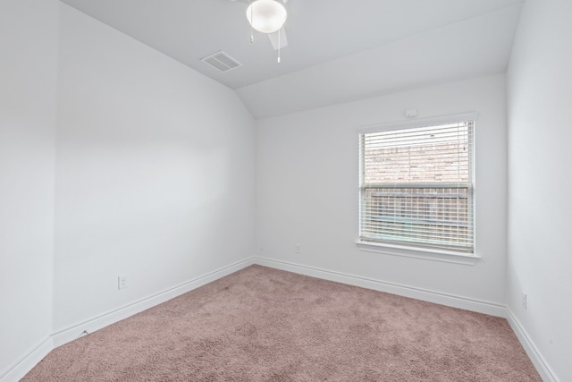 spare room with vaulted ceiling and carpet