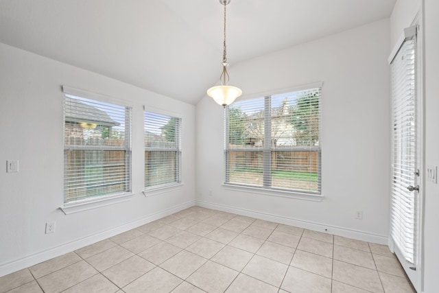 unfurnished dining area featuring light tile patterned flooring, lofted ceiling, and a healthy amount of sunlight