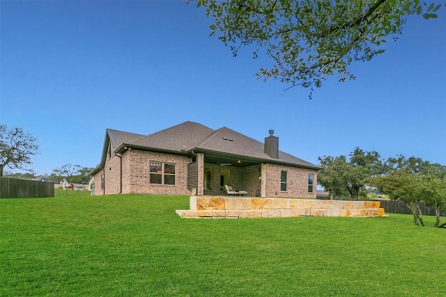 rear view of house with a yard