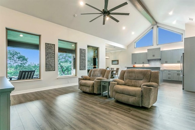 living room with beam ceiling, dark hardwood / wood-style floors, high vaulted ceiling, and ceiling fan