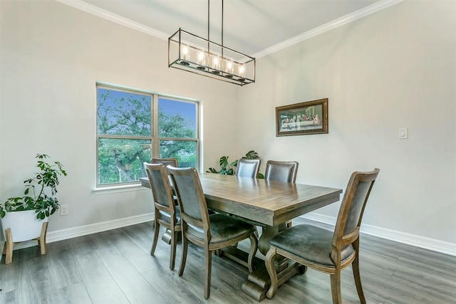 dining room featuring dark hardwood / wood-style floors and crown molding