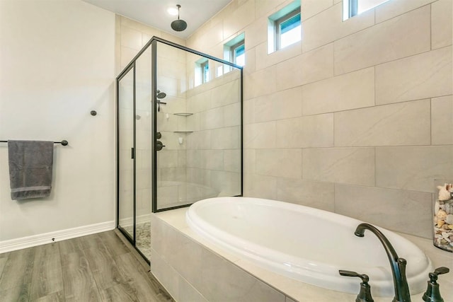 bathroom with hardwood / wood-style flooring and plus walk in shower