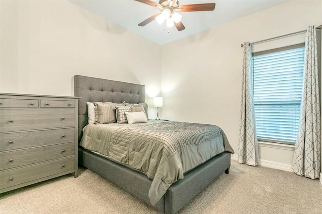 bedroom with multiple windows, light colored carpet, and ceiling fan