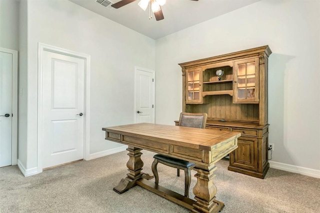 carpeted office featuring ceiling fan