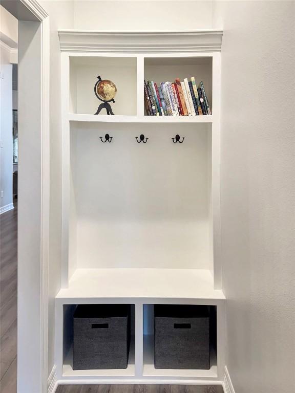 mudroom featuring hardwood / wood-style flooring and built in features