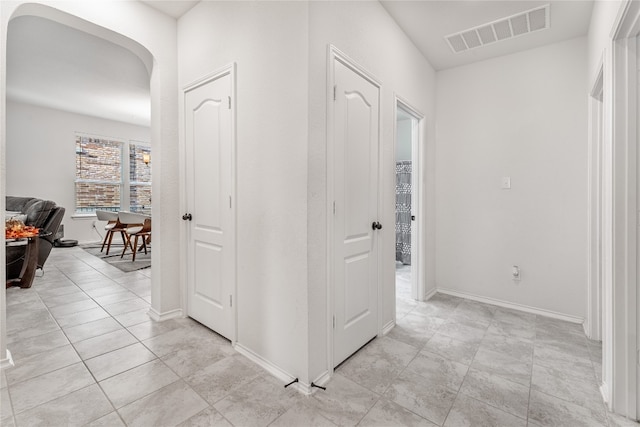 corridor with light tile patterned floors