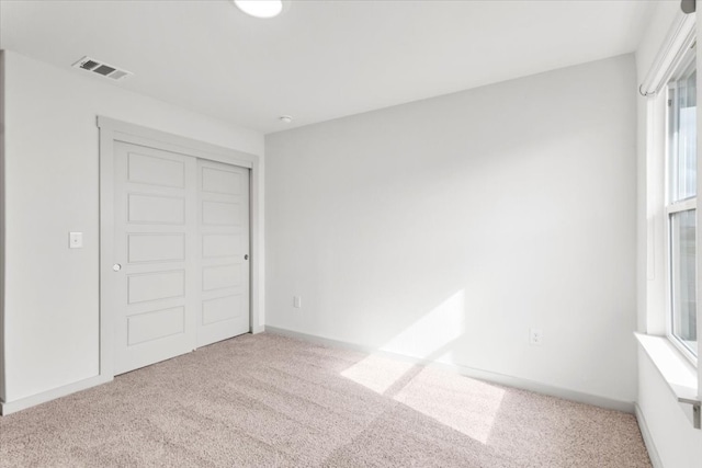 unfurnished bedroom featuring a closet and carpet