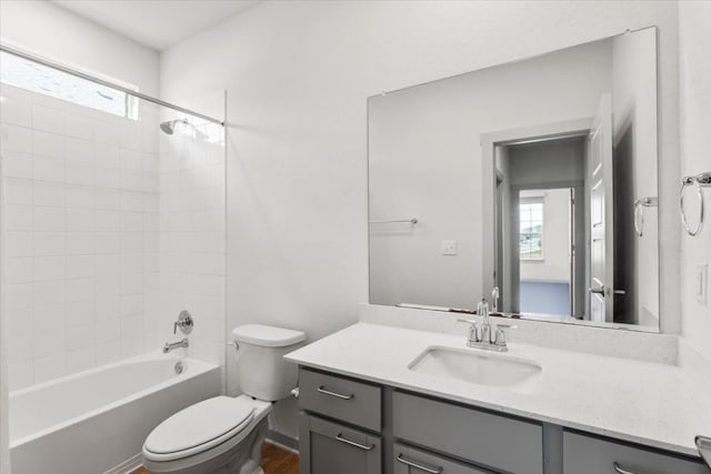 full bathroom featuring plenty of natural light, tiled shower / bath, toilet, and vanity