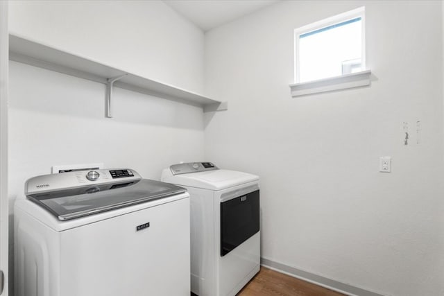 laundry area featuring dark wood-type flooring and washer and dryer