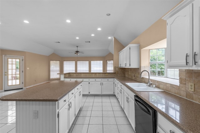 kitchen featuring lofted ceiling, dishwasher, decorative backsplash, sink, and white cabinetry