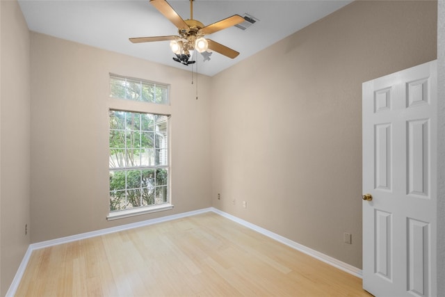 spare room with ceiling fan and light wood-type flooring