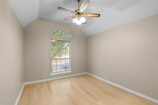 spare room featuring light hardwood / wood-style floors, ceiling fan, and lofted ceiling