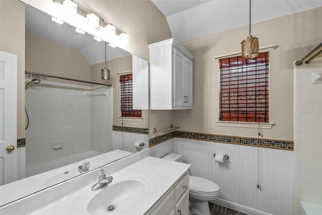 10018 Wild Dunes Dr, Austin, TX 78747 - bathroom with  shower combination, vanity, tile walls, a wainscoted wall, and tile patterned flooring