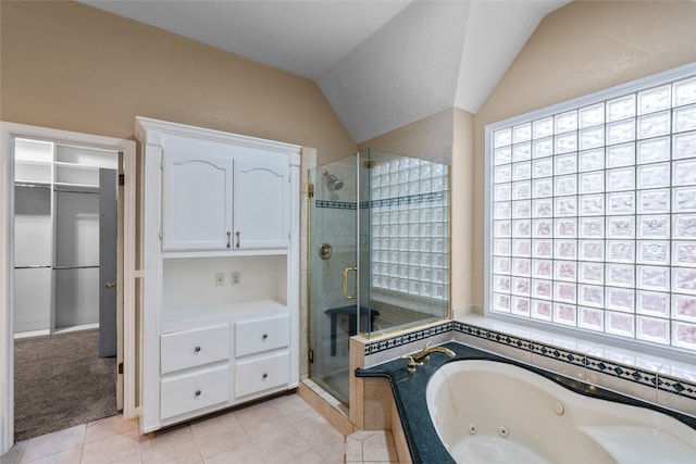 bathroom with independent shower and bath, tile patterned flooring, a healthy amount of sunlight, and lofted ceiling