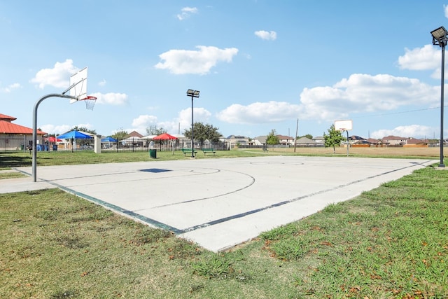 view of sport court with a yard