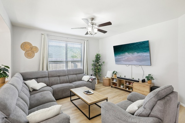 living room with light hardwood / wood-style flooring and ceiling fan